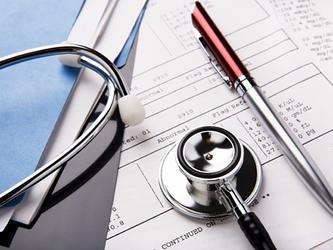 stethoscope on top of medical report